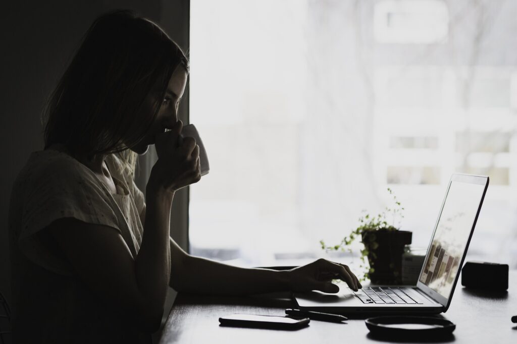 Another Person's Family Tree is Not a Valid Source - Woman Researching at Her Laptop